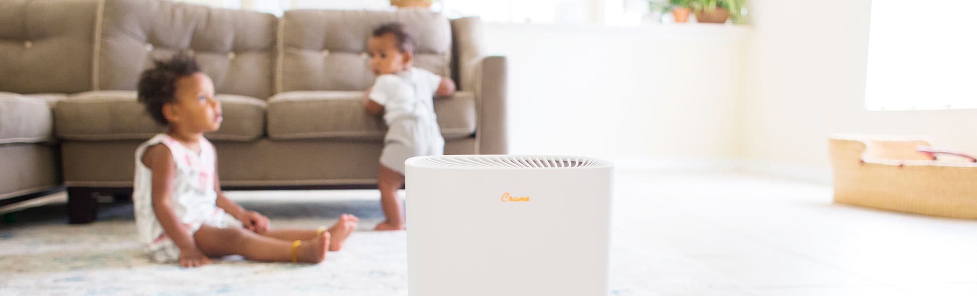 Air purifier in front of 2 small kids