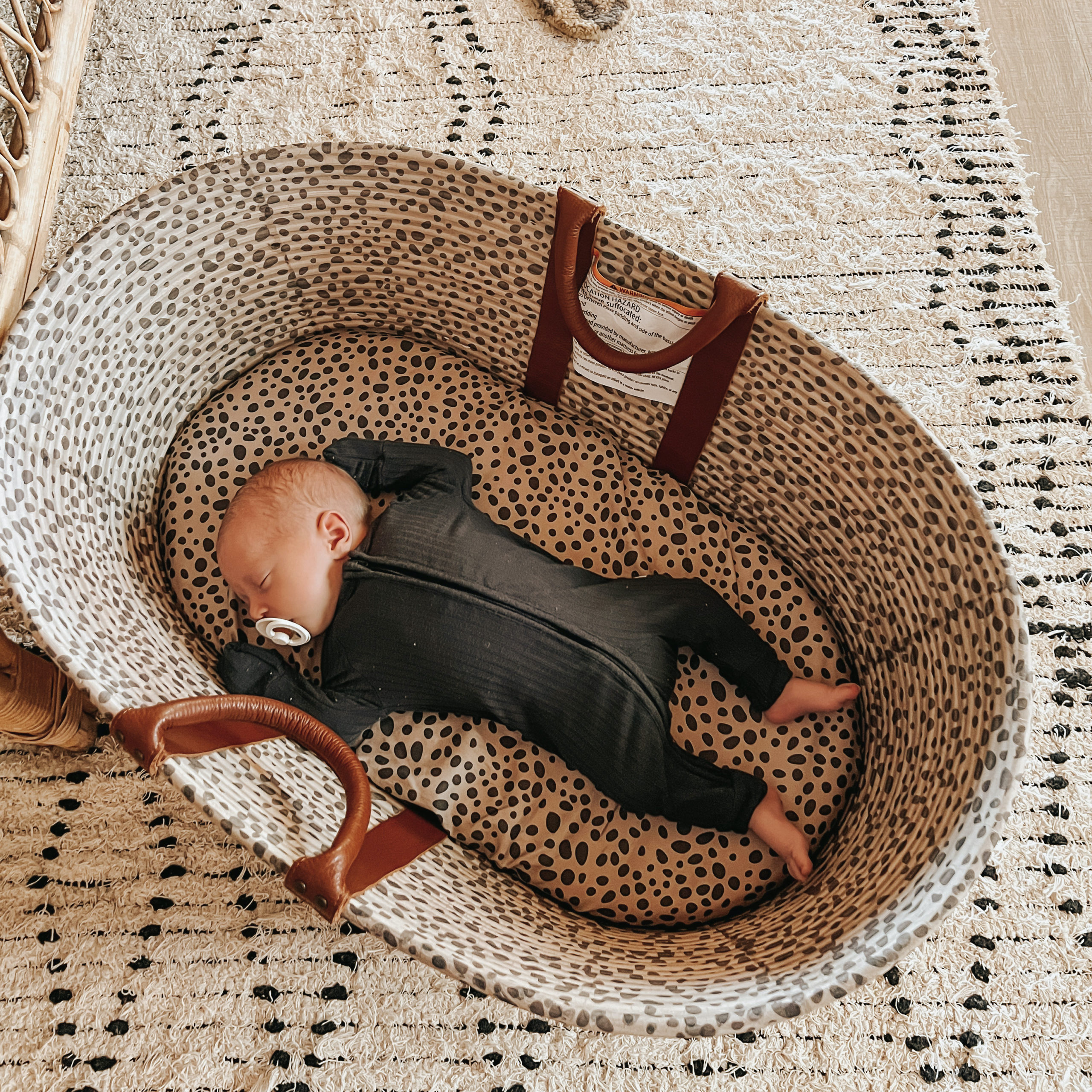 infant napping in a bassinet