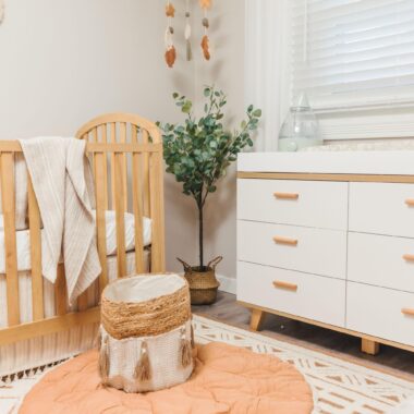 Corner of a nursery with a crib and changing table