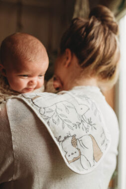 Mom holding baby over burp cloth
