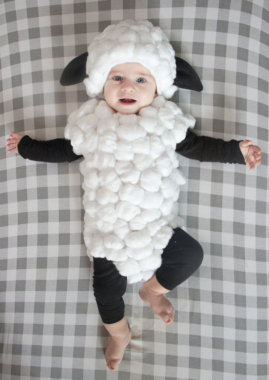 Baby wearing a lamb costume