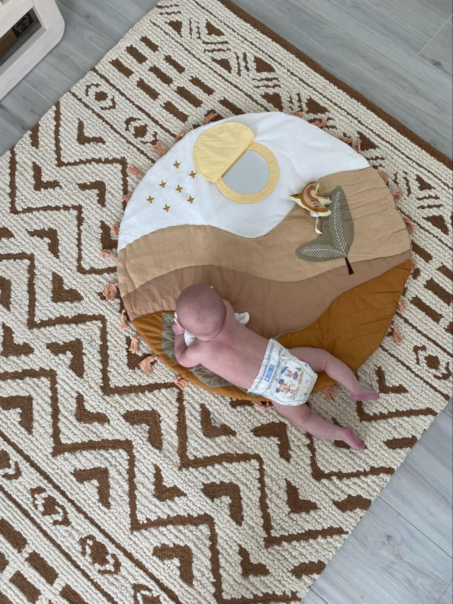 Baby doing tummy time on a play mat