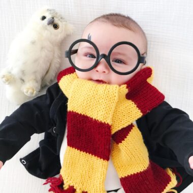 Baby dressed up as Harry Potter with glasses and a scarf