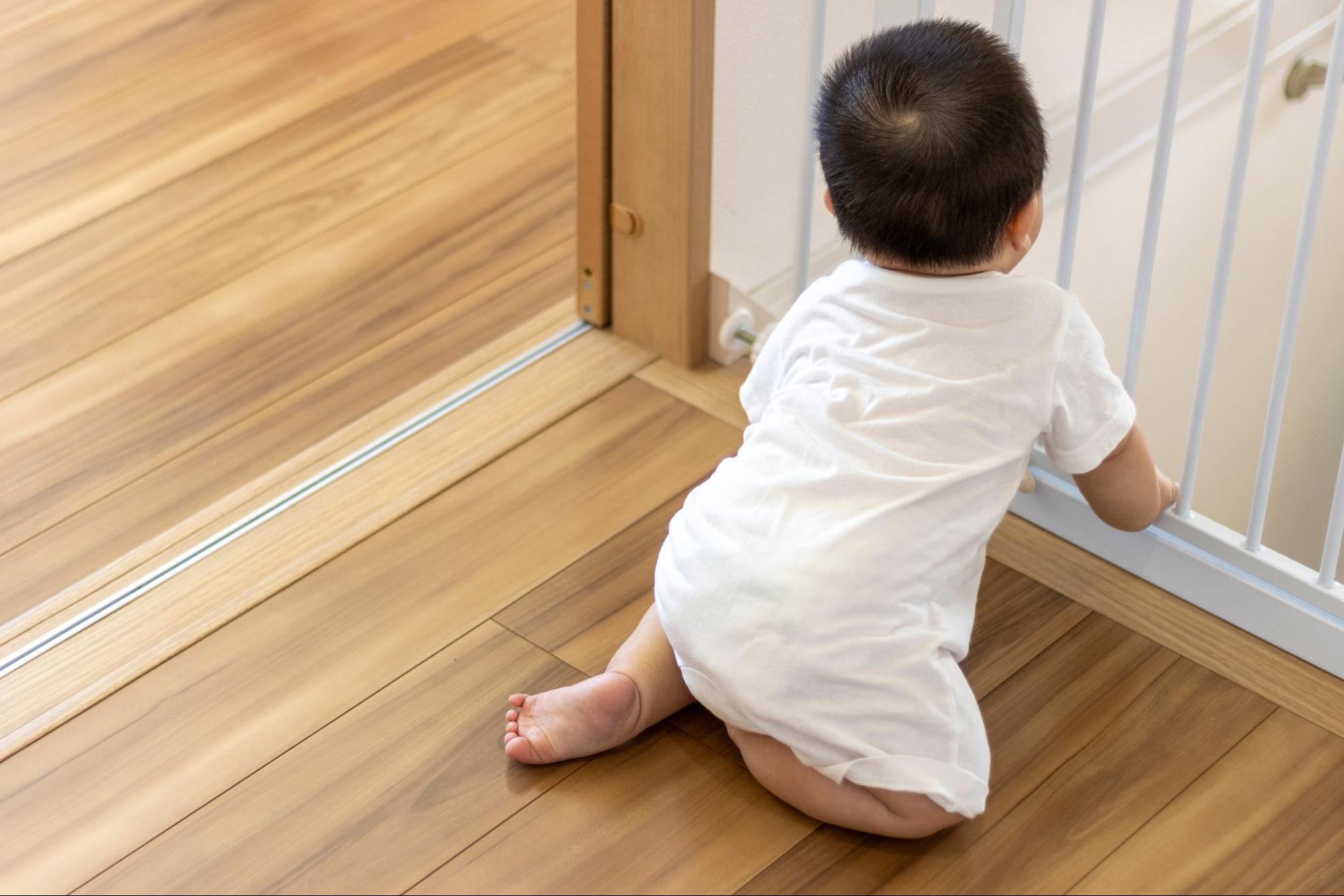 Baby climbing a baby gate