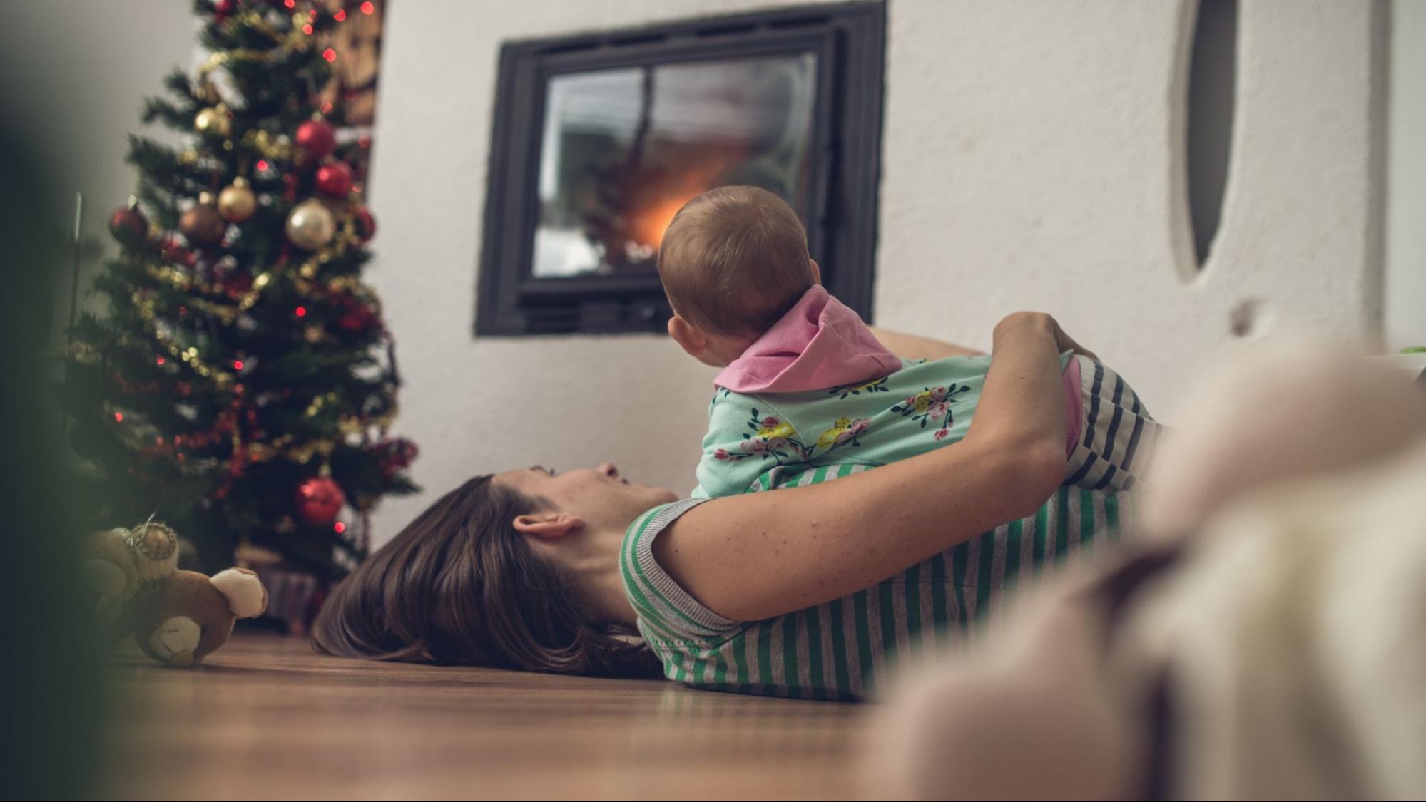Mom lying on the floor with her baby on top