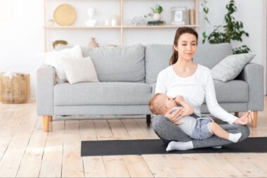 Mom meditating while breastfeeding baby in lap