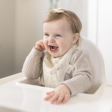 Smiling baby in a high chair