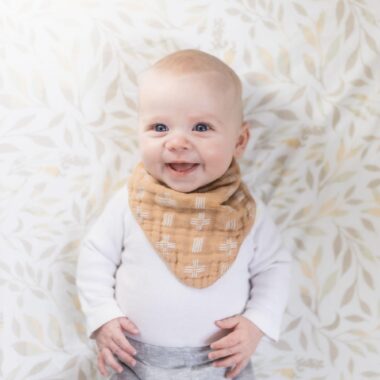 Smiling baby wearing a bib