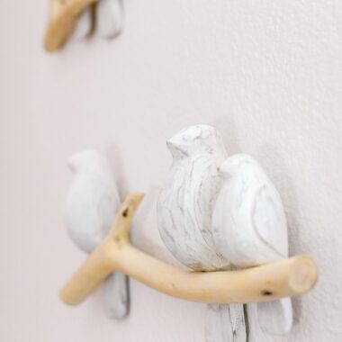 Close up of wooden birds and branch wall decor