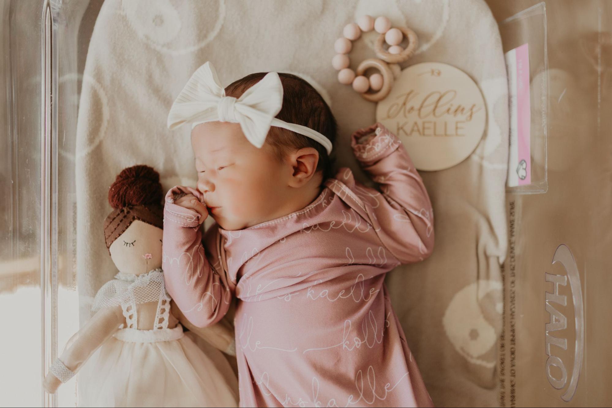 Baby asleep in a delivery room bassinet