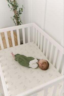 Baby lying down in a crib