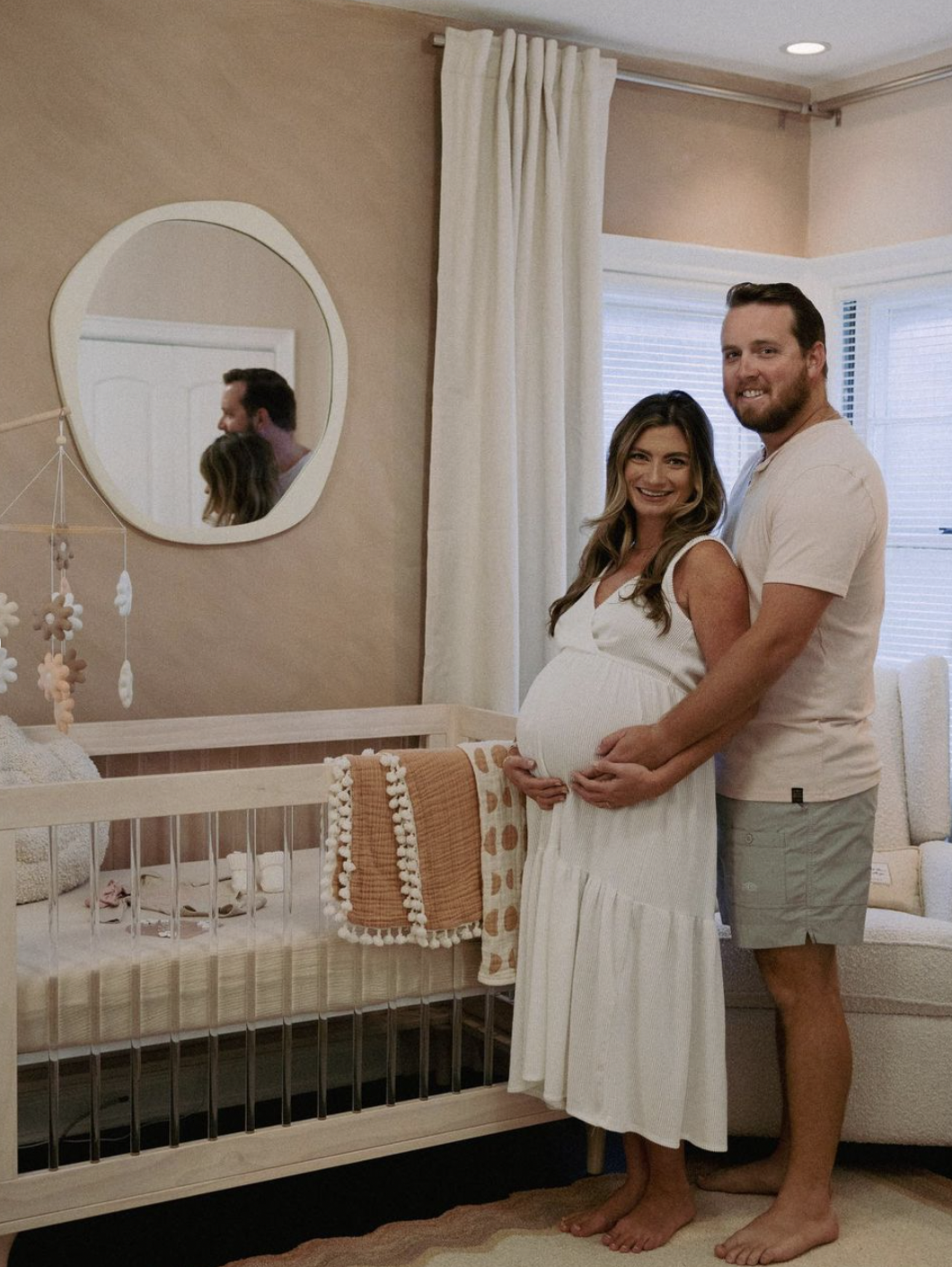 happy couple expecting a baby in nursery