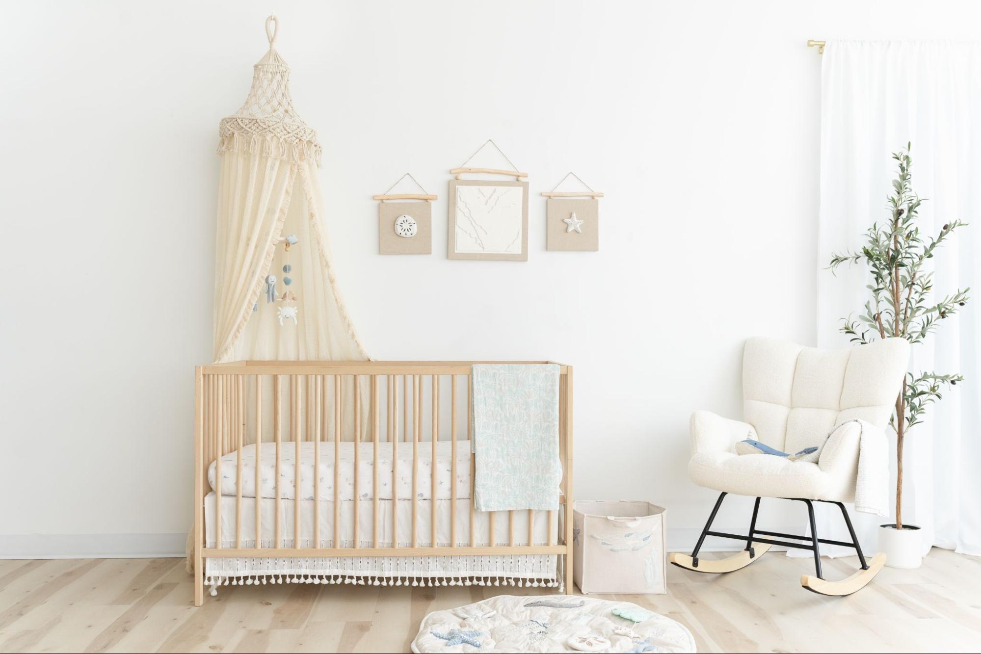 Wooden crib along the wall in a ocean themed nursery