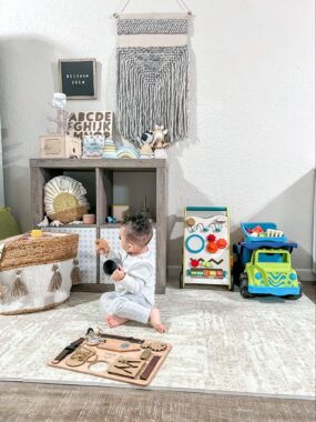 Baby playing with toys on a rug