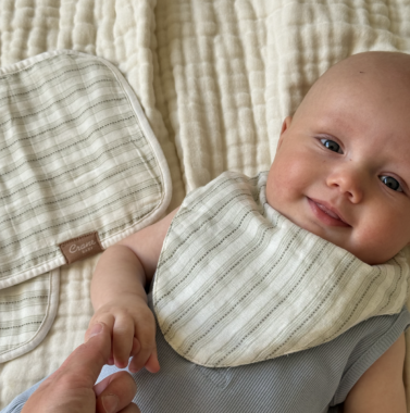 Smiling baby wearing a bib