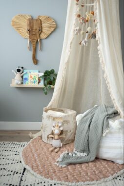 Storage bin and blankets on a play mat
