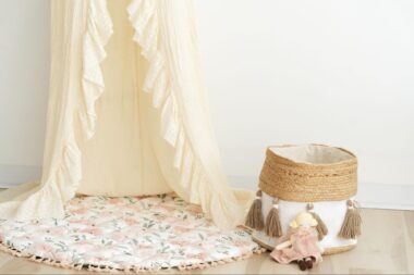 Canopy draped over a play mat