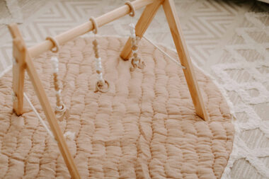 Baby play gym on top of a play mat