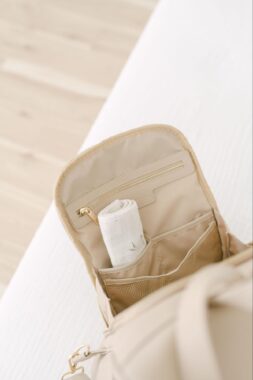 Blanket rolled into the pocket of an open diaper bag