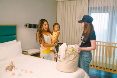 Mother and daughter looking excitedly at a bin full of baby toys 