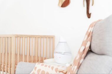 Humidifier on a corner table next to a crib