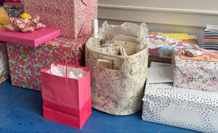 Collection of baby shower gifts and cards