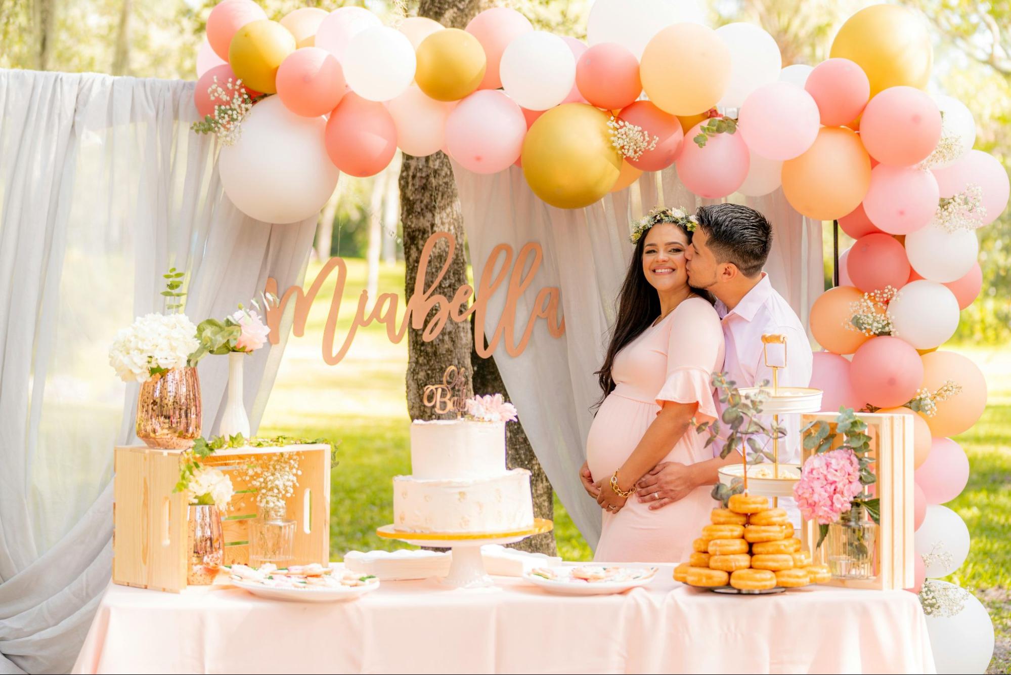 Husband kissing his pregnant wife at a baby shower