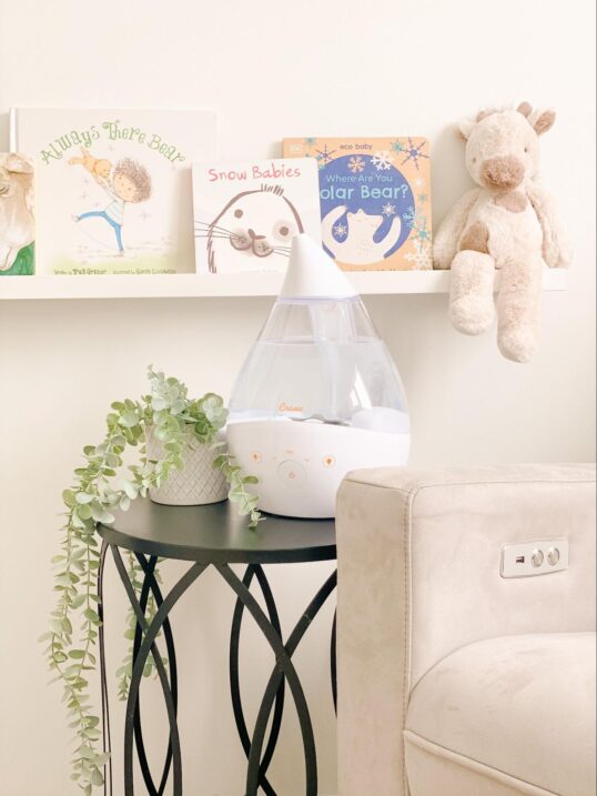 Humidifier on a table in front of a book shelf