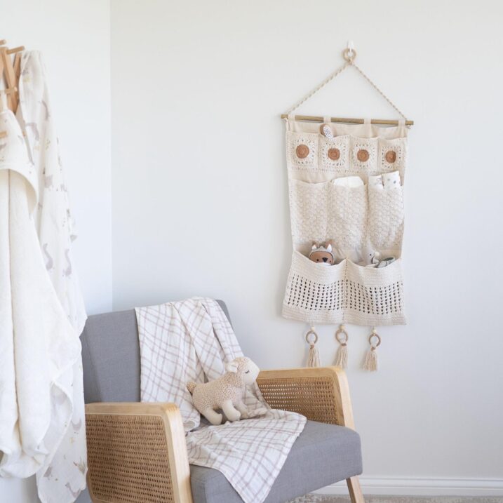 Hanging nursery storage on the wall next to a rocking chair