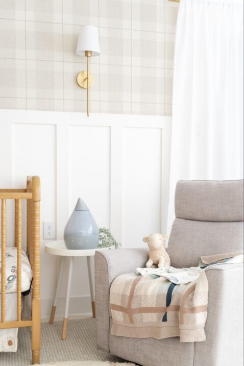 Nursery humidifier on a table next to a glider