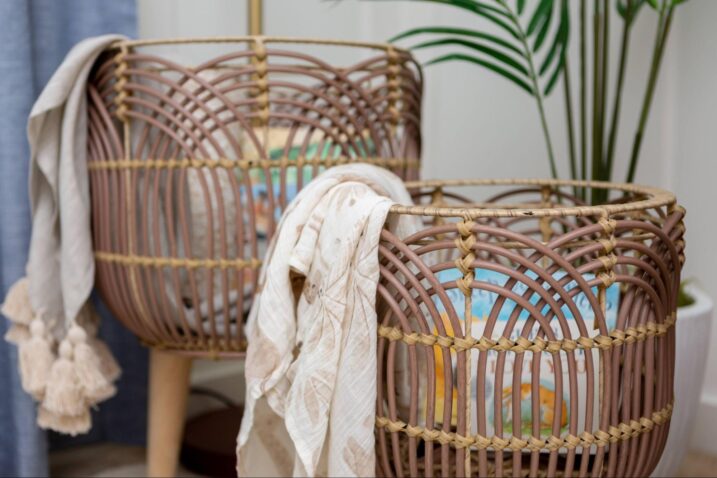 Storage bins full of swaddle blankets and baby books